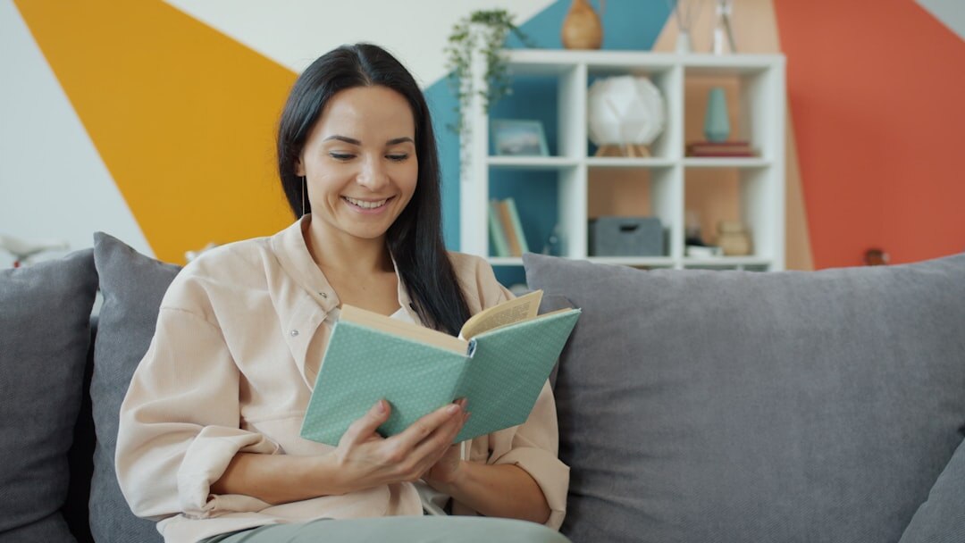 woman reading book at home