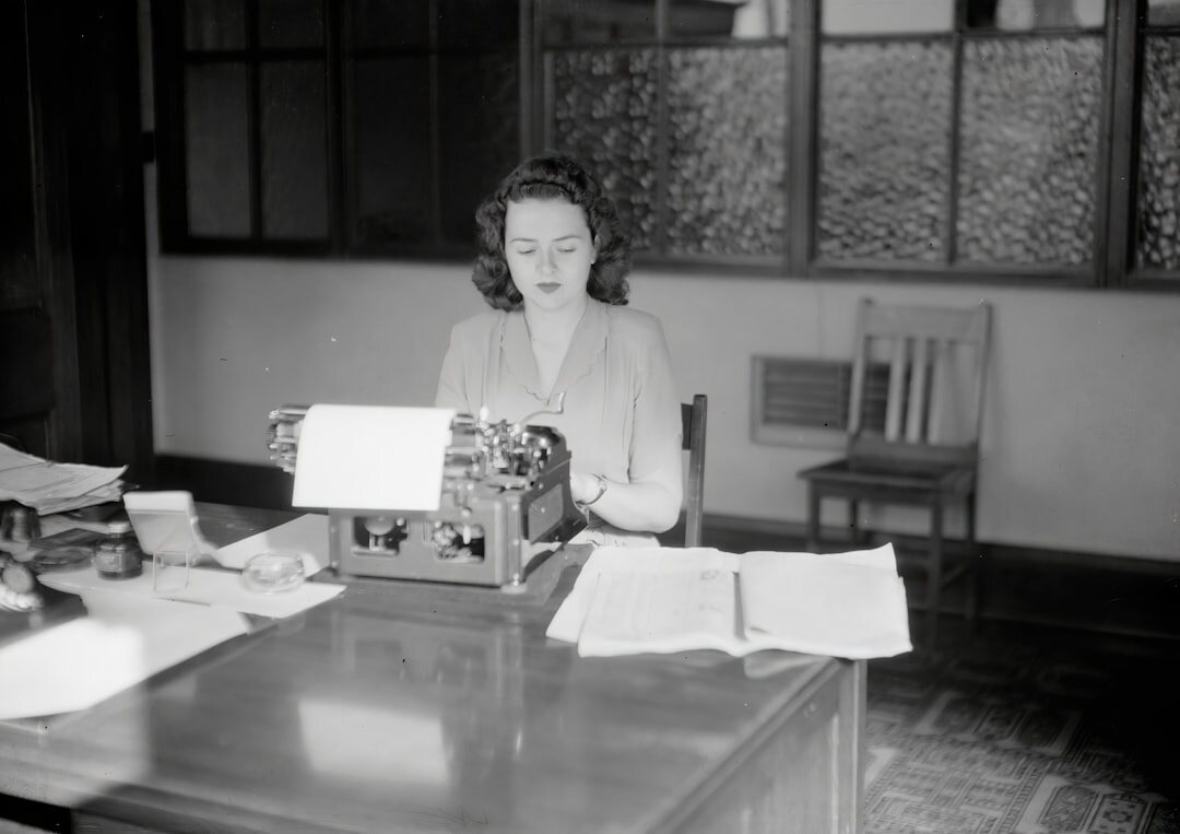 woman writing mystery novel at desk